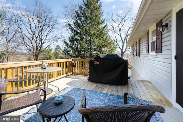 wooden deck with a grill