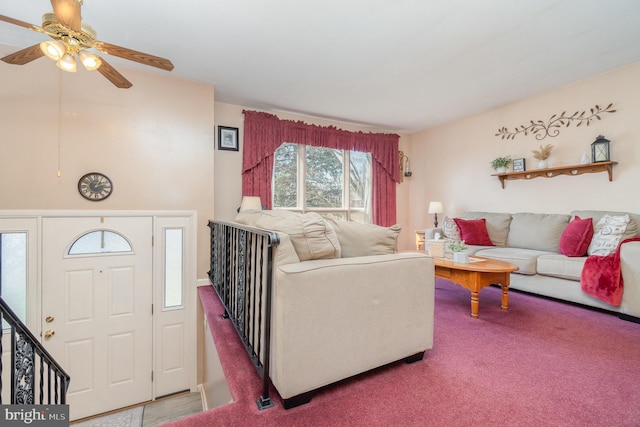 carpeted living room featuring a ceiling fan