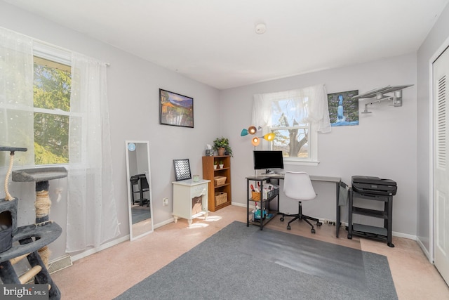 carpeted home office featuring baseboards