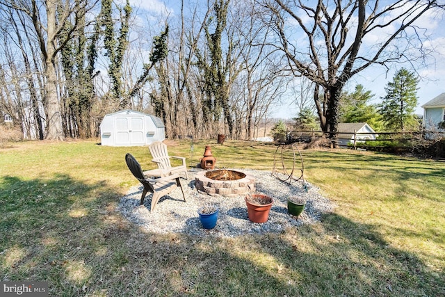 view of yard featuring a shed, an outdoor fire pit, and an outdoor structure