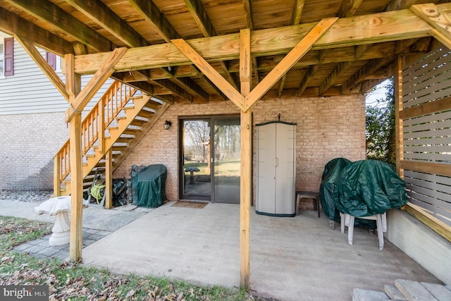 view of patio / terrace with stairway and a grill