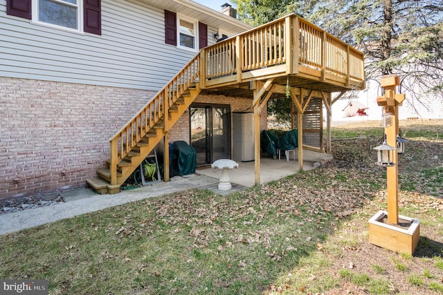 exterior space featuring stairway, a wooden deck, and a patio area