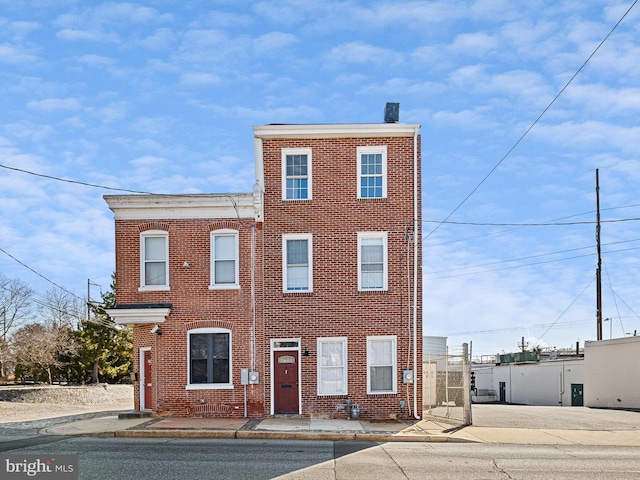 multi unit property with a chimney and brick siding