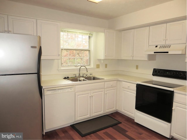 kitchen featuring white dishwasher, under cabinet range hood, a sink, electric stove, and freestanding refrigerator