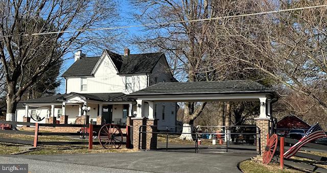 view of community featuring a fenced front yard, driveway, and a gate