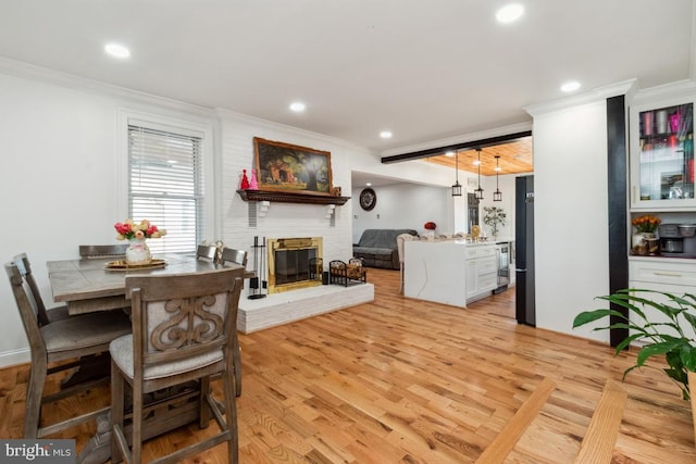 3524 Blenheim Rd, Phoenix, MD 21131 - dining room featuring recessed lighting, a fireplace, light wood-type flooring, and crown molding