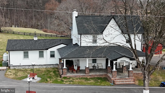 3524 Blenheim Rd, Phoenix, MD 21131 - view of front facade with a front yard, fence, a chimney, and a shingled roof