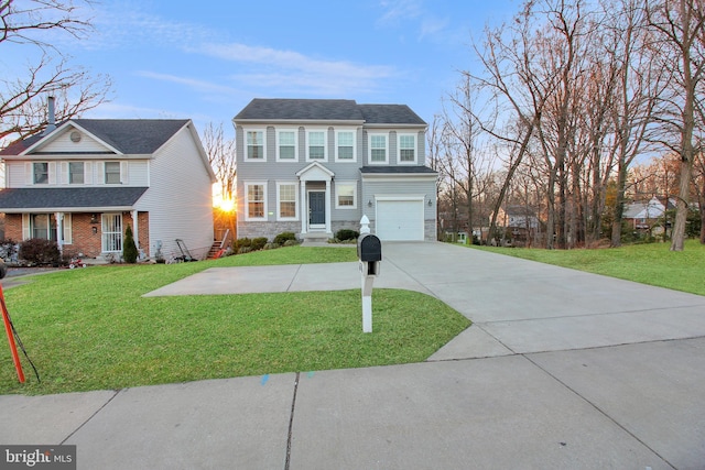 view of front of property with a garage, driveway, a front lawn, and stone siding