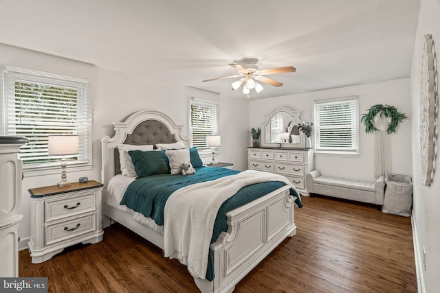 bedroom featuring ceiling fan, dark wood-type flooring, and multiple windows