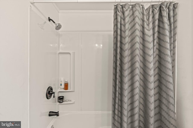 bathroom featuring ornamental molding and shower / tub combo