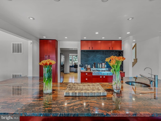 kitchen featuring recessed lighting, visible vents, a sink, and decorative backsplash