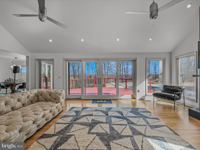 living room featuring lofted ceiling, ceiling fan, wood finished floors, and recessed lighting