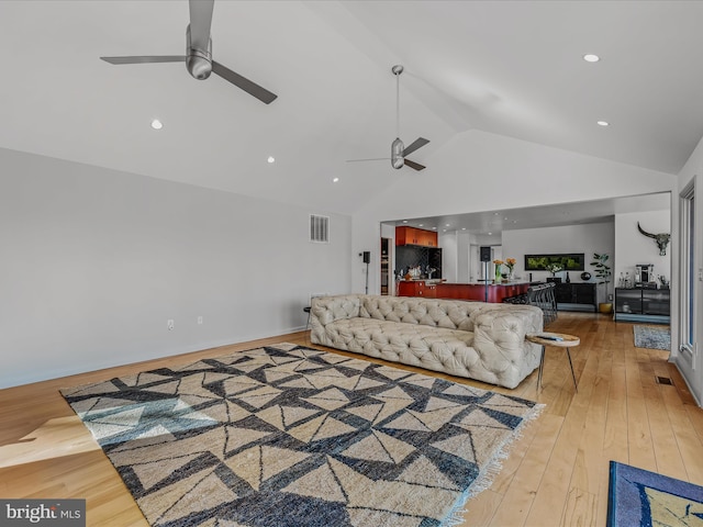 living room with light wood finished floors, visible vents, a ceiling fan, high vaulted ceiling, and recessed lighting