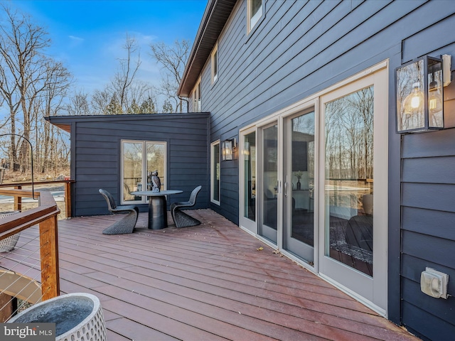 wooden terrace featuring outdoor dining area