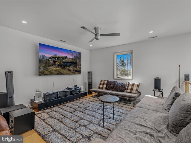 living room featuring a ceiling fan, recessed lighting, visible vents, and wood finished floors