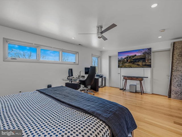 bedroom featuring light wood-type flooring, a ceiling fan, and recessed lighting