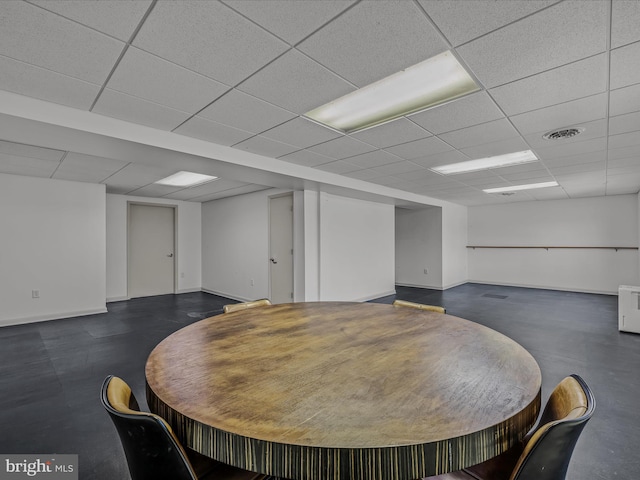 dining room featuring a paneled ceiling, baseboards, and visible vents