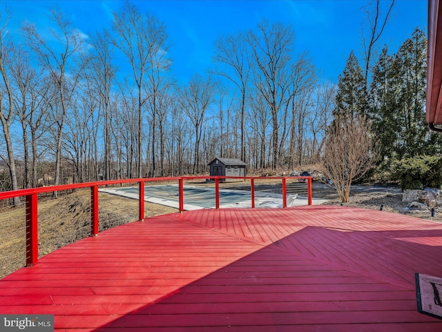 wooden deck with an outdoor structure and a storage unit