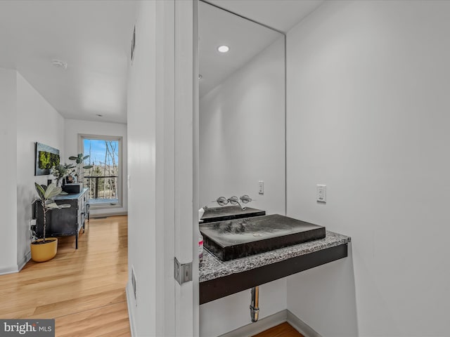 bathroom with wood finished floors and recessed lighting