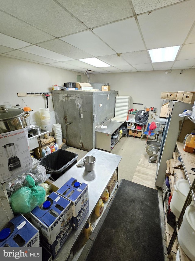 kitchen featuring concrete floors and a drop ceiling