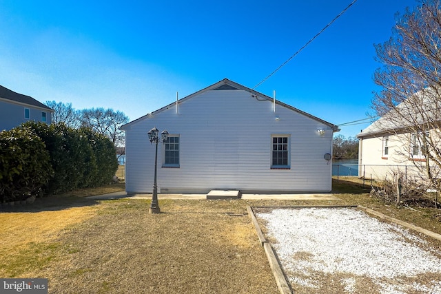 rear view of house featuring a yard