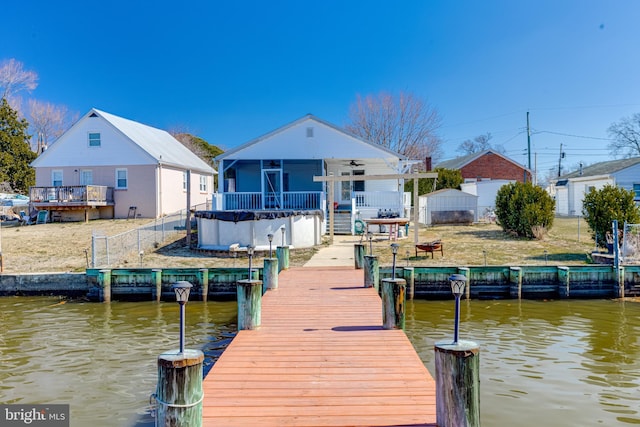 dock area featuring a water view and fence