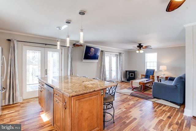 kitchen featuring light wood-style flooring, ornamental molding, stainless steel appliances, and french doors