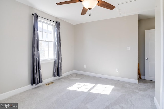 unfurnished room featuring attic access, light carpet, visible vents, and baseboards