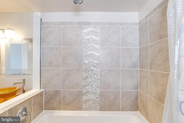 bathroom featuring a tub to relax in, a sink, and a shower with curtain