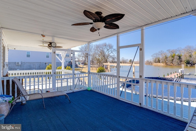 exterior space featuring a ceiling fan and a water view