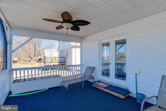 view of patio with a ceiling fan and a balcony