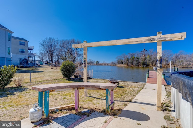 view of dock featuring a water view and fence