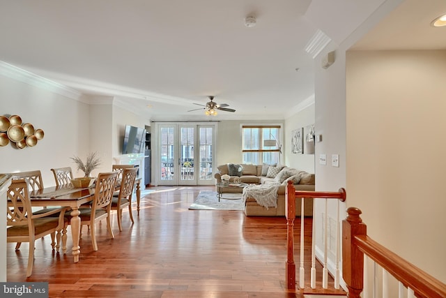 interior space featuring ornamental molding, french doors, ceiling fan, and wood finished floors