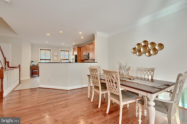 dining space with light wood finished floors, stairway, ornamental molding, and recessed lighting