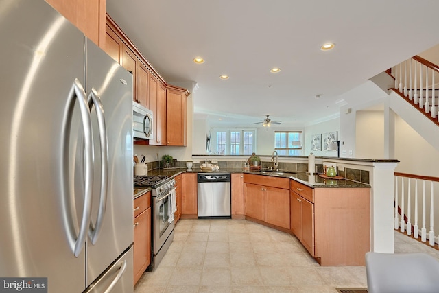 kitchen with stainless steel appliances, recessed lighting, a sink, and a peninsula