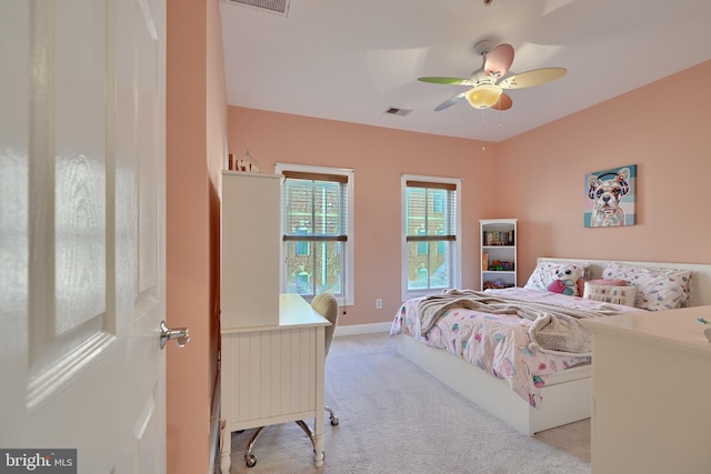 bedroom featuring light carpet, ceiling fan, visible vents, and baseboards