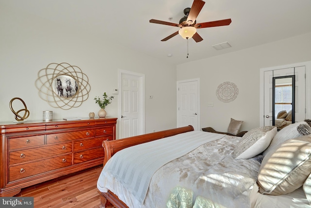 bedroom with light wood finished floors and a ceiling fan