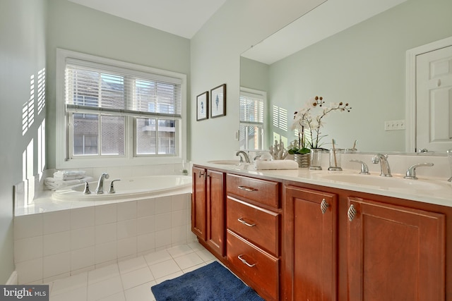 full bath with double vanity, tile patterned flooring, a sink, and a bath