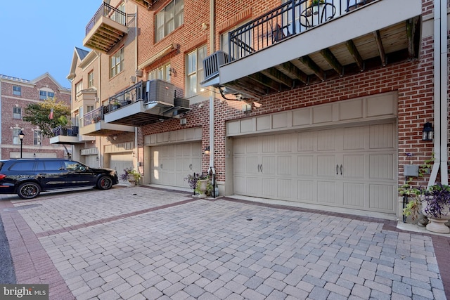 garage with decorative driveway