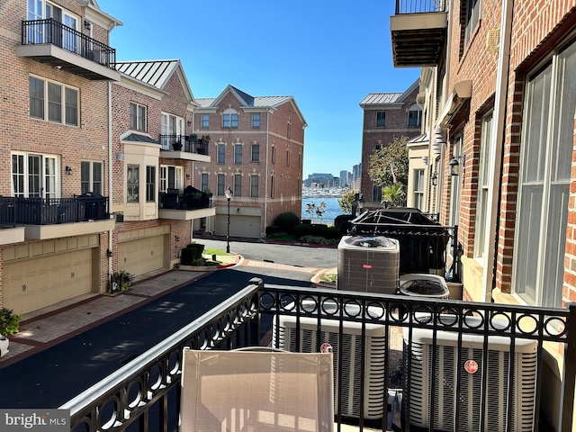 balcony with central AC unit and a city view