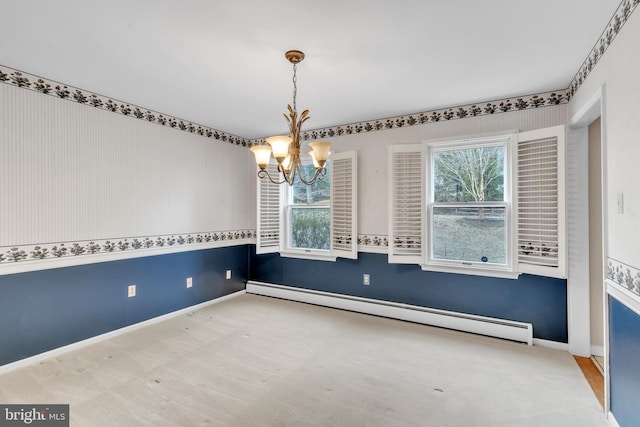 unfurnished dining area with a baseboard radiator, baseboards, a healthy amount of sunlight, and a chandelier