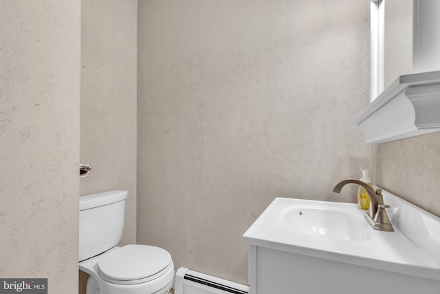 half bathroom featuring vanity, toilet, and a baseboard radiator