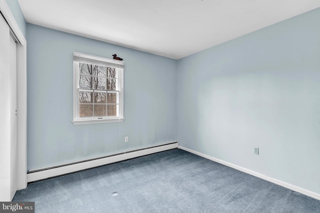 unfurnished bedroom with a closet, carpet flooring, a baseboard heating unit, and baseboards