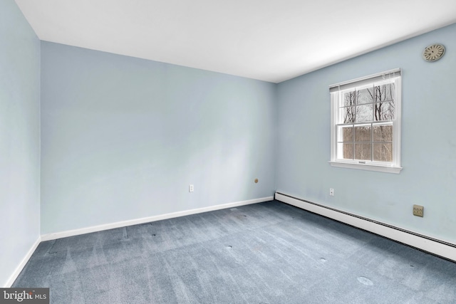 carpeted spare room featuring baseboard heating and baseboards