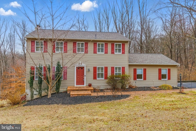 colonial inspired home with a front yard