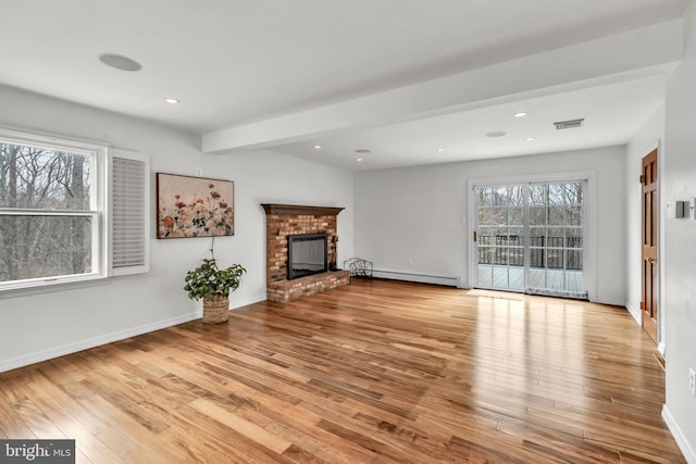 unfurnished living room featuring a brick fireplace, recessed lighting, wood finished floors, and baseboard heating