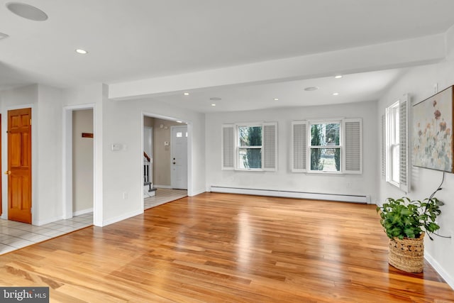 unfurnished living room featuring baseboards, stairway, baseboard heating, recessed lighting, and wood finished floors