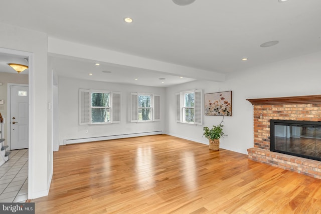 unfurnished living room with recessed lighting, a baseboard radiator, a brick fireplace, and light wood-style flooring