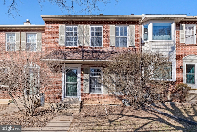 townhome / multi-family property featuring brick siding