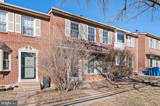 townhome / multi-family property with brick siding